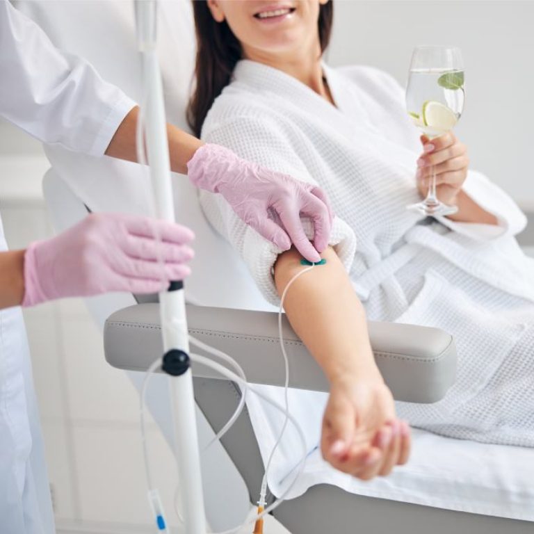 smiling female patient undergoing intravenous vita 2023 11 27 04 59 32 utc 1